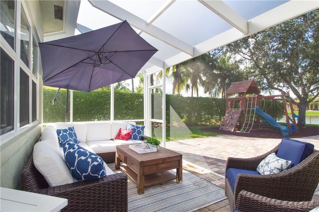 13841 Southwest 44th Street Davie, FL 33330 - Photo 30 of 40 a outdoor space with patio the couches and a umbrella