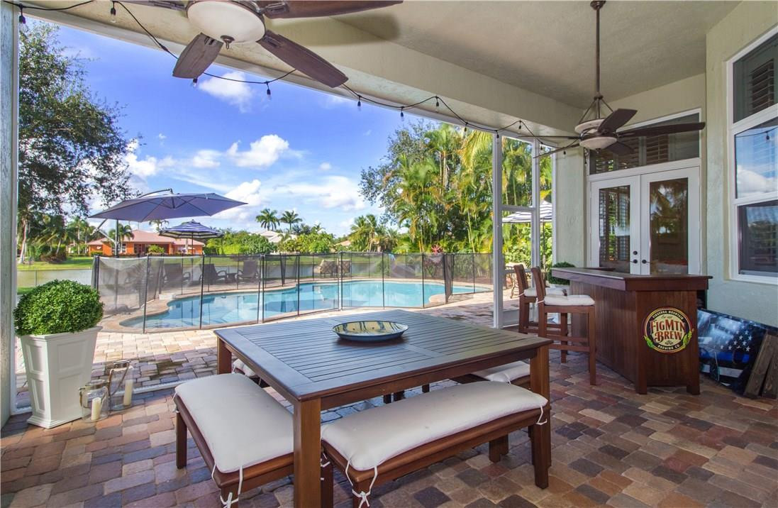 13841 Southwest 44th Street Davie, FL 33330 - Photo 31 of 40 a view of a patio with a dining table and chairs
