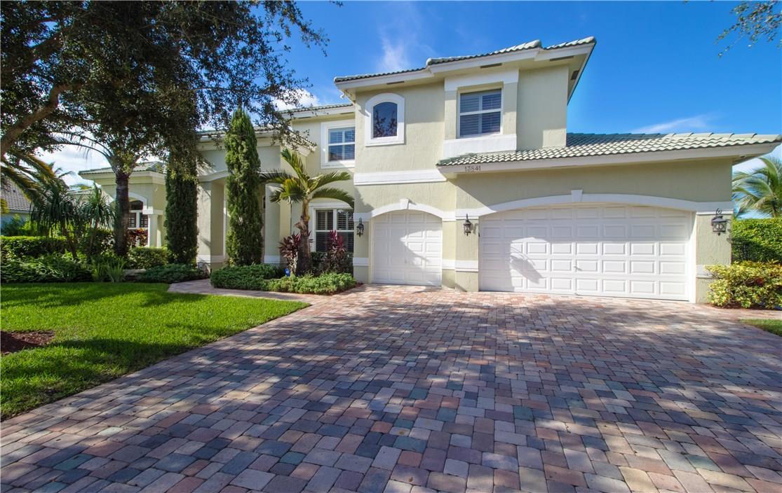 13841 Southwest 44th Street Davie, FL 33330 - Photo 39 of 40 a front view of a house with a yard and garage