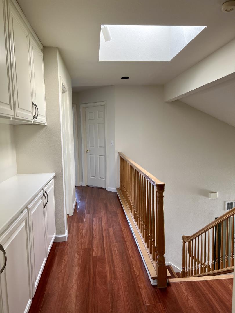 11792 Pine Brook Lane Cupertino, CA 95014 - Photo 8 of 19 a view of a hallway with wooden floor and staircase