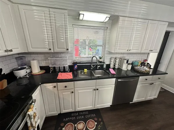 a bedroom with a bed and a refrigerator