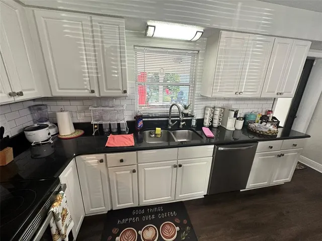 a bedroom with a bed and a refrigerator