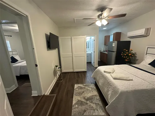 a bedroom with a bed and a chandelier