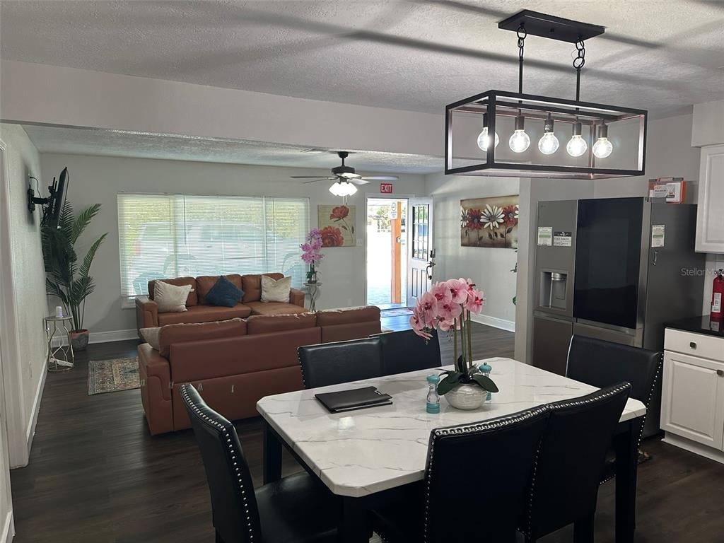 16903 Hanna Road Lutz, FL 33549 - Photo 20 of 94 a view of a dining room with furniture a chandelier and wooden floor
