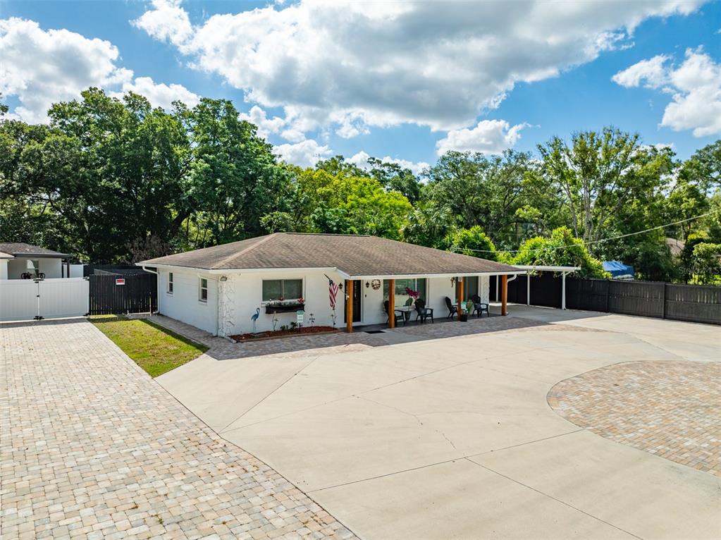 16903 Hanna Road Lutz, FL 33549 - Photo 2 of 94 a front view of a house with a yard and trees