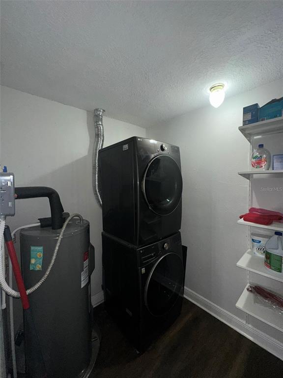 16903 Hanna Road Lutz, FL 33549 - Photo 21 of 94 a room with water heater and wooden cabinets
