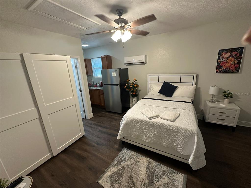 16903 Hanna Road Lutz, FL 33549 - Photo 23 of 94 a bedroom with a bed and a refrigerator