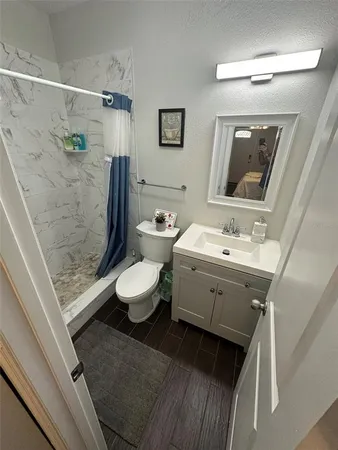 a bathroom with a double vanity sink mirror and toilet