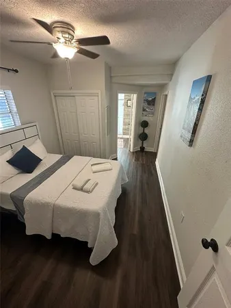 a bedroom with a bed and a flat tv screen on a dresser