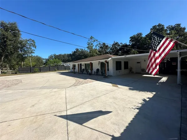 a view of a house with a backyard