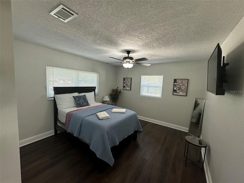 16903 Hanna Road Lutz, FL 33549 - Photo 43 of 94 a bedroom with a bed and a flat tv screen on a dresser