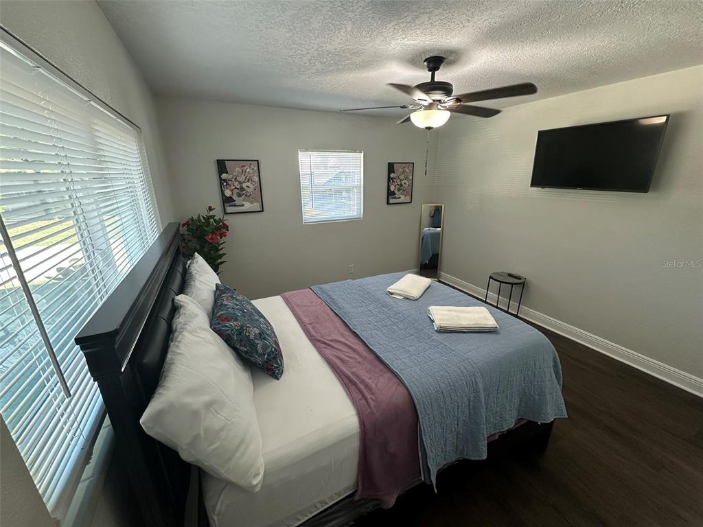 16903 Hanna Road Lutz, FL 33549 - Photo 44 of 94 a bedroom with a bed and a flat screen tv