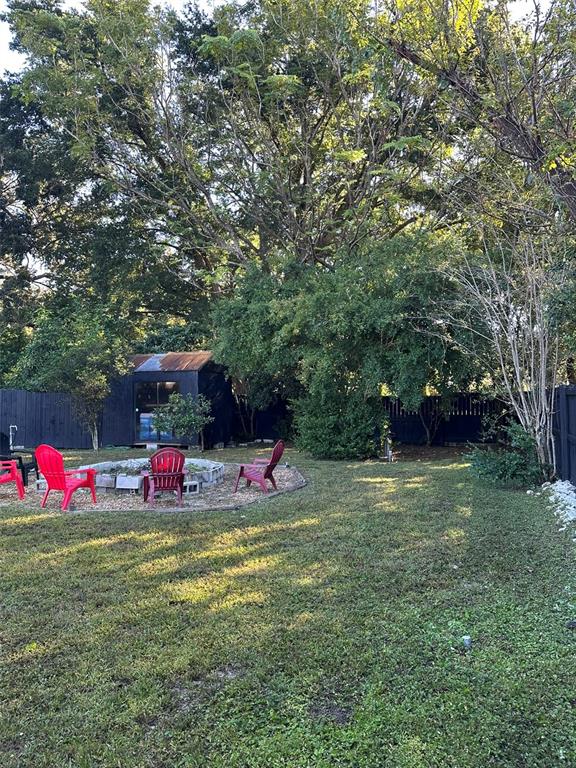 16903 Hanna Road Lutz, FL 33549 - Photo 58 of 94 a view of a backyard with table and chairs and potted plants and large trees