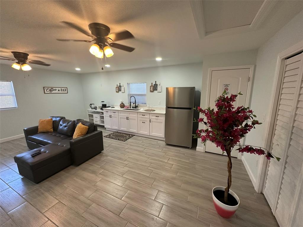16903 Hanna Road Lutz, FL 33549 - Photo 69 of 94 a living room with furniture flowers and a chandelier