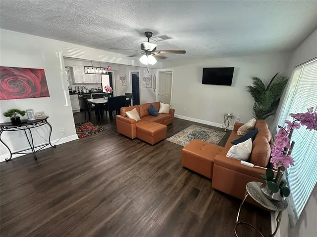 a living room with furniture fireplace and a window