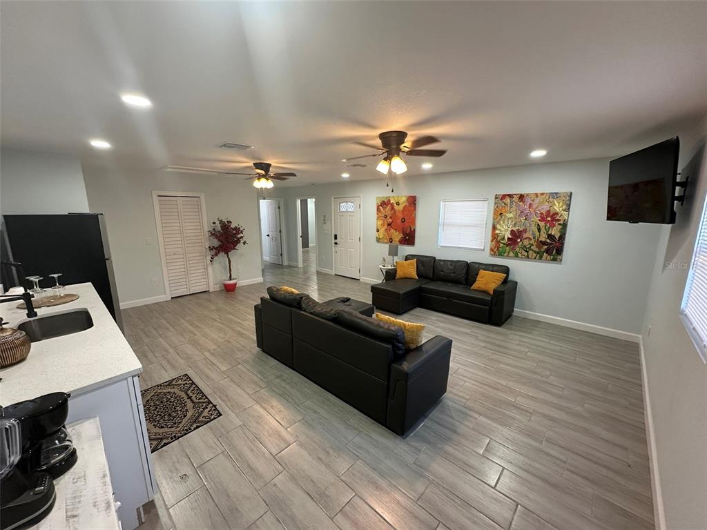 16903 Hanna Road Lutz, FL 33549 - Photo 73 of 94 a living room with furniture and a flat screen tv