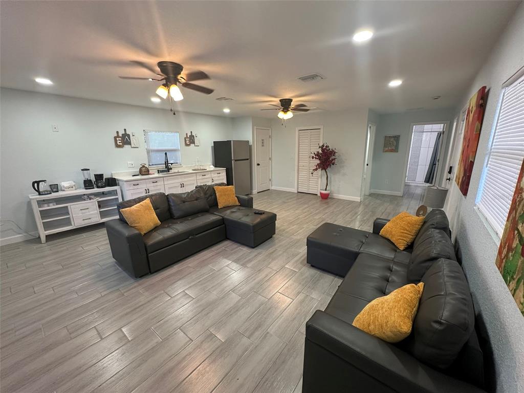 16903 Hanna Road Lutz, FL 33549 - Photo 74 of 94 a living room with furniture and a large mirror