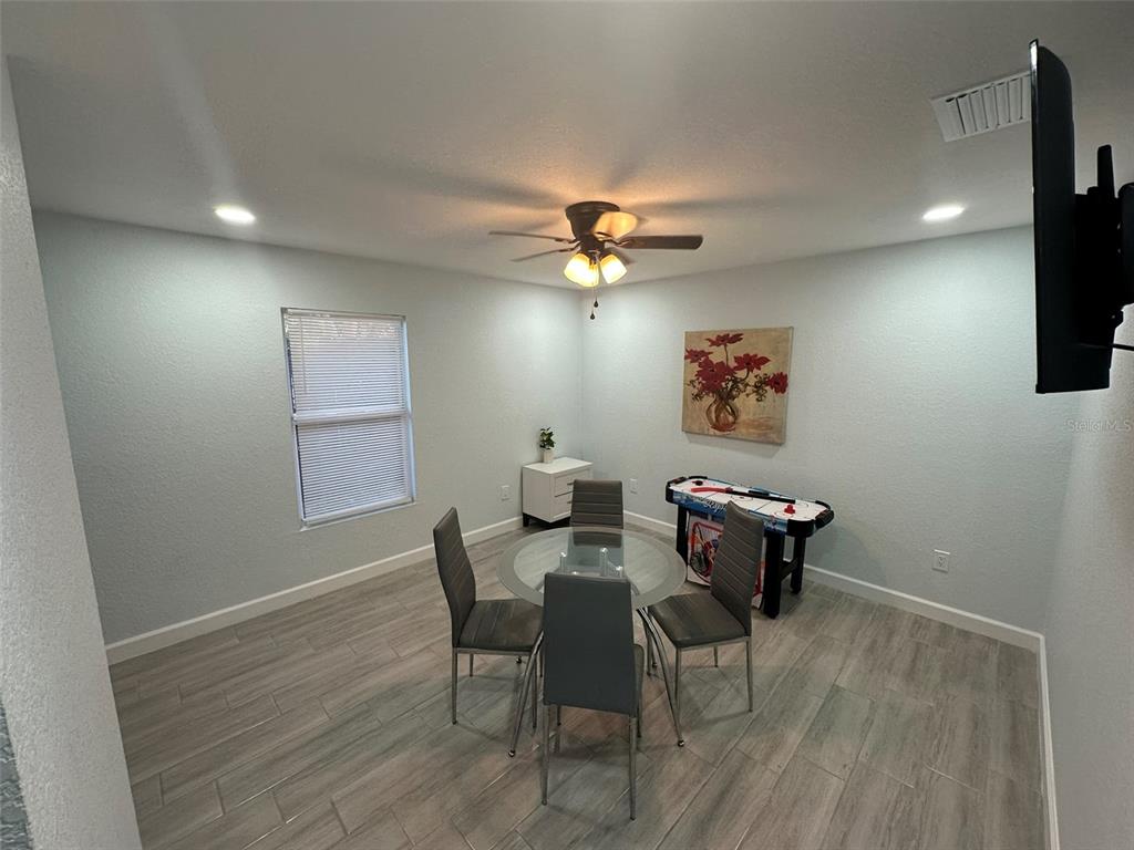 16903 Hanna Road Lutz, FL 33549 - Photo 75 of 94 a view of a dining room with furniture and a chandelier fan