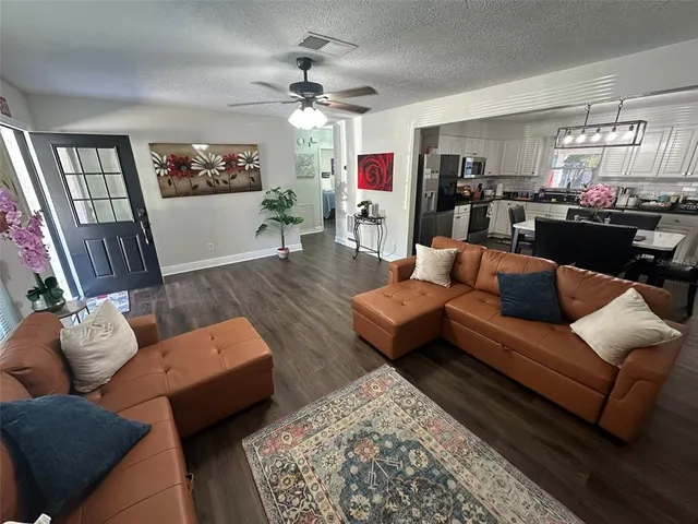 a living room with furniture and a chandelier