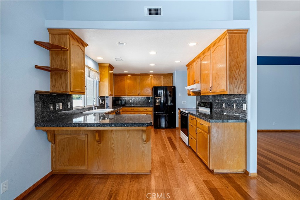 9340 Mountain View Drive Atascadero, CA 93422 - Photo 11 of 50 a kitchen with stainless steel appliances granite countertop a stove a sink and a refrigerator
