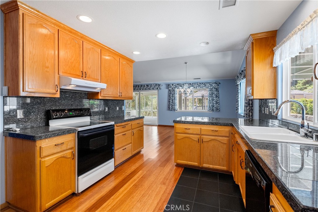 9340 Mountain View Drive Atascadero, CA 93422 - Photo 12 of 50 a kitchen with stainless steel appliances granite countertop sink stove top oven and cabinets