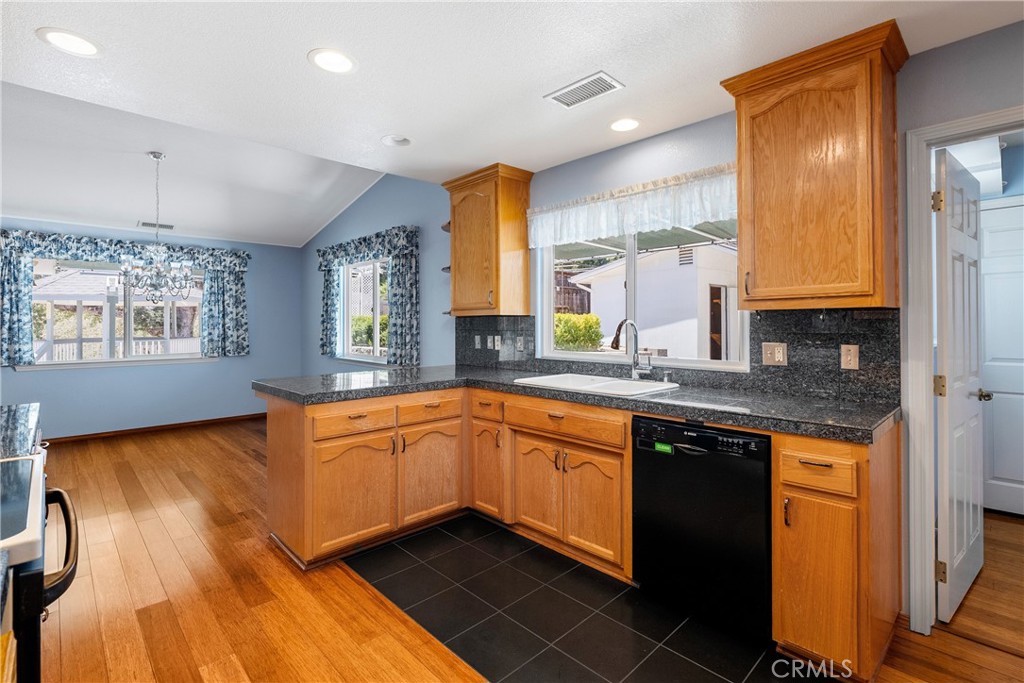9340 Mountain View Drive Atascadero, CA 93422 - Photo 49 of 50 a kitchen with stainless steel appliances granite countertop a sink a stove cabinets and wooden floor