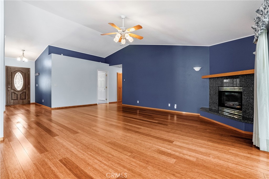 9340 Mountain View Drive Atascadero, CA 93422 - Photo 16 of 50 a view of empty room with wooden floor and fireplace