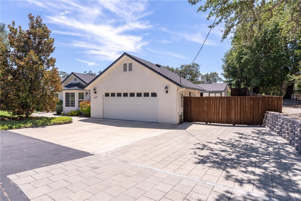 9340 Mountain View Drive Atascadero, CA 93422 - Photo 2 of 50 a front view of a house with a yard and garage