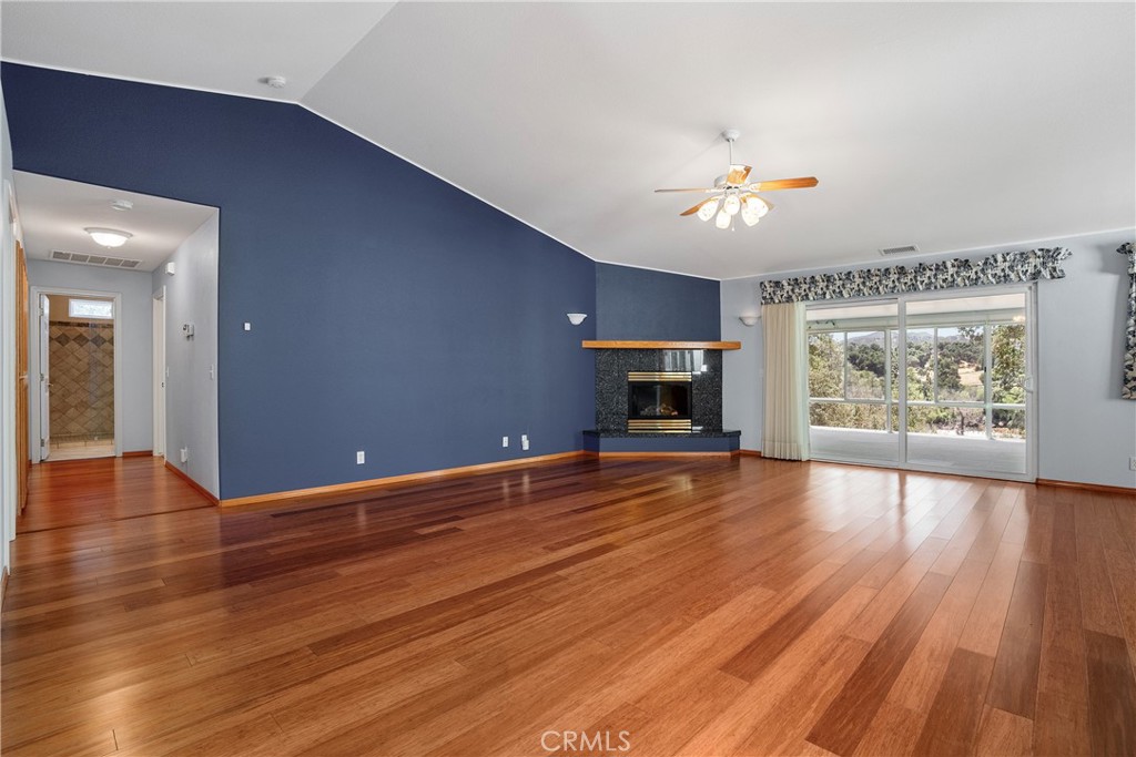9340 Mountain View Drive Atascadero, CA 93422 - Photo 8 of 50 an empty room with wooden floor and a fireplace