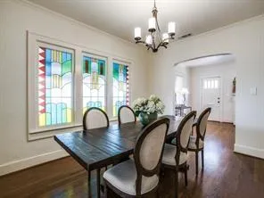 a dining room with furniture a window and wooden floor