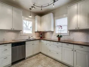 a kitchen with sink cabinets and window