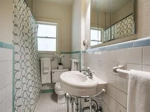 a bathroom with a sink a toilet and mirror
