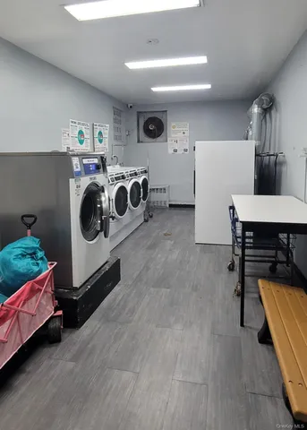 a utility room with multiple dryer and washer