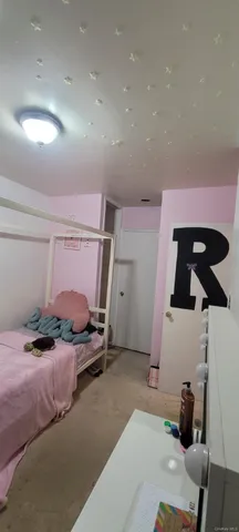 a bedroom with a bed and cabinets