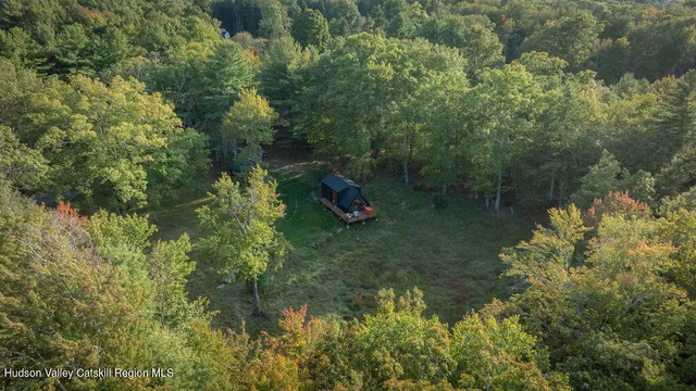a backyard of a house with wooden floor and fence