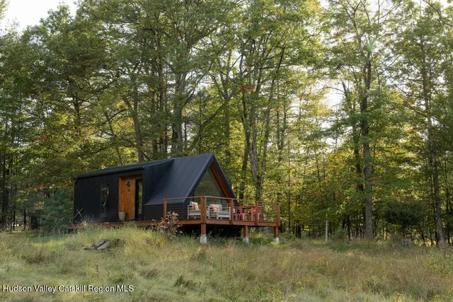 a view of house with outdoor space and sitting area