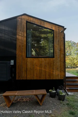a view of a back yard of the house with a lake view