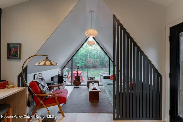 a living room with furniture a fireplace and a floor to ceiling window
