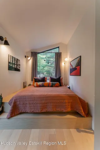 a bedroom with a bed and window