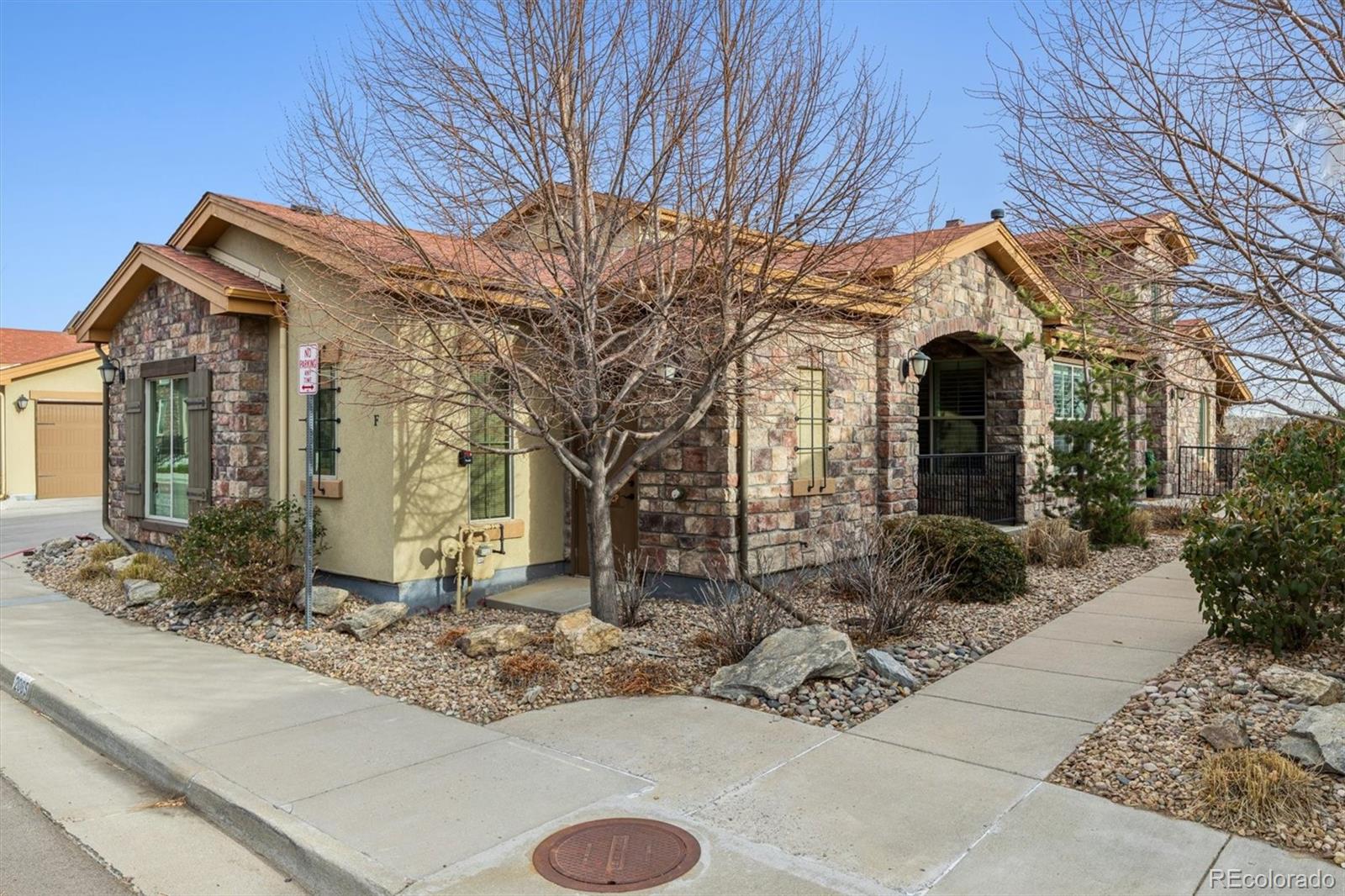 2065 Primo Road, Unit F Highlands Ranch, CO 80129 - Photo 1 of 37 a front view of a house with garden