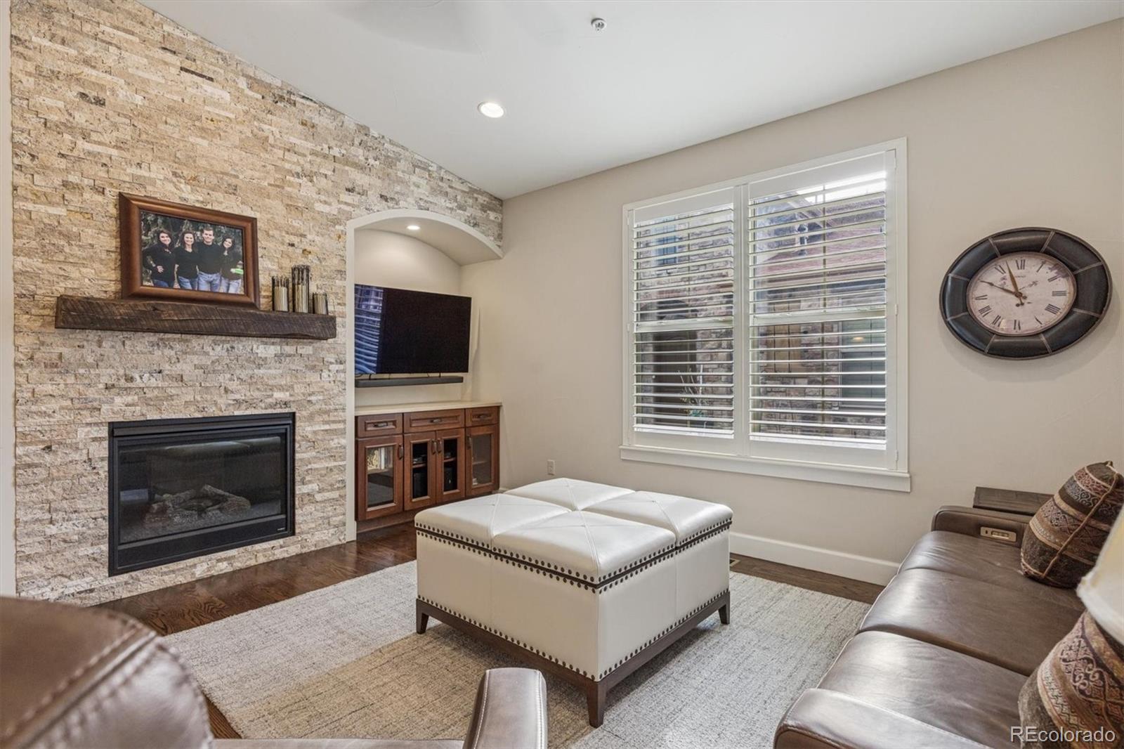 2065 Primo Road, Unit F Highlands Ranch, CO 80129 - Photo 14 of 37 a living room with furniture a flat screen tv and a fireplace