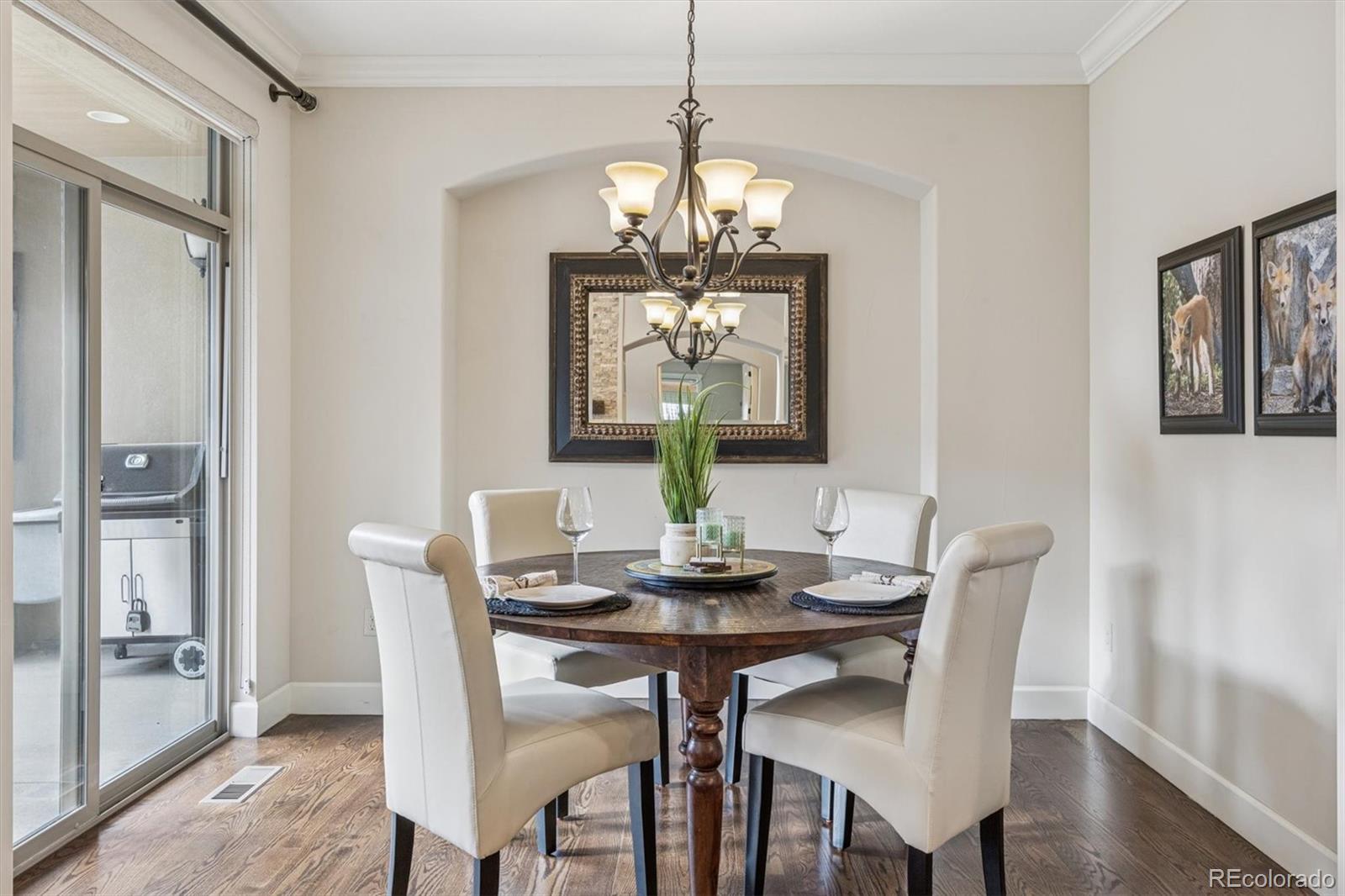 2065 Primo Road, Unit F Highlands Ranch, CO 80129 - Photo 15 of 37 a dining room with furniture a chandelier and wooden floor