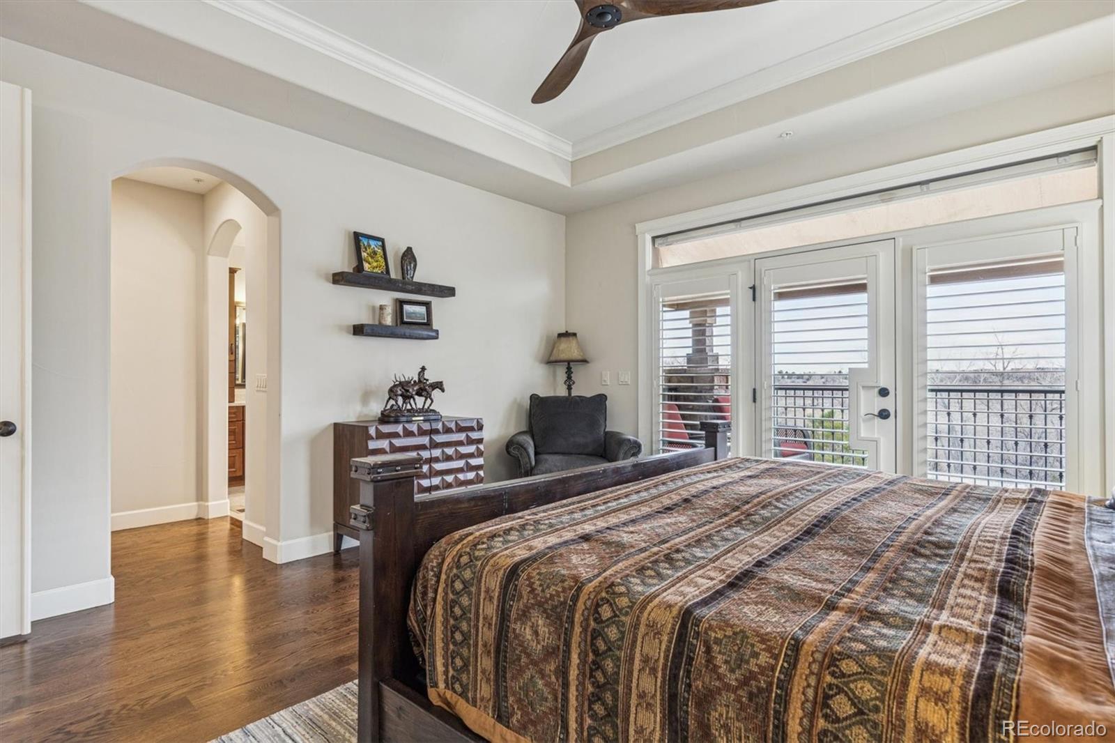 2065 Primo Road, Unit F Highlands Ranch, CO 80129 - Photo 19 of 37 a bedroom with a bed and wooden floor