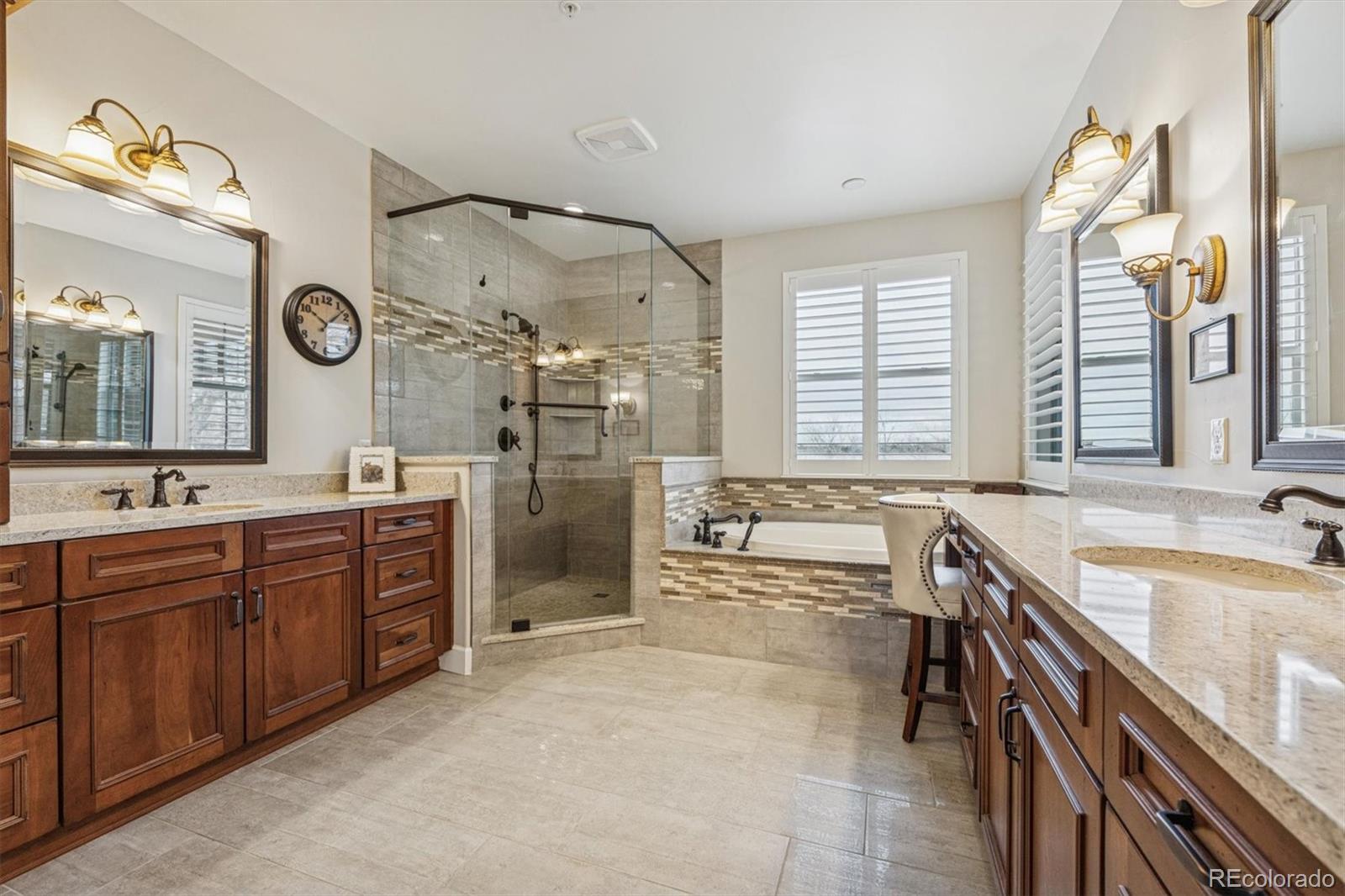 2065 Primo Road, Unit F Highlands Ranch, CO 80129 - Photo 20 of 37 a bathroom with a granite countertop sink mirror and a bathtub