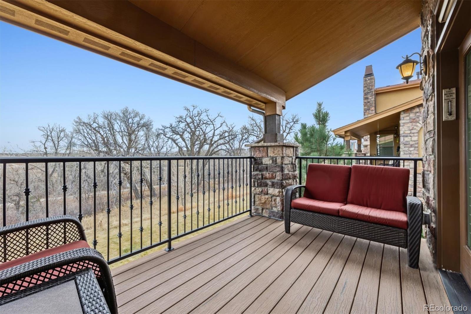 2065 Primo Road, Unit F Highlands Ranch, CO 80129 - Photo 25 of 37 a balcony with wooden floor and outdoor seating