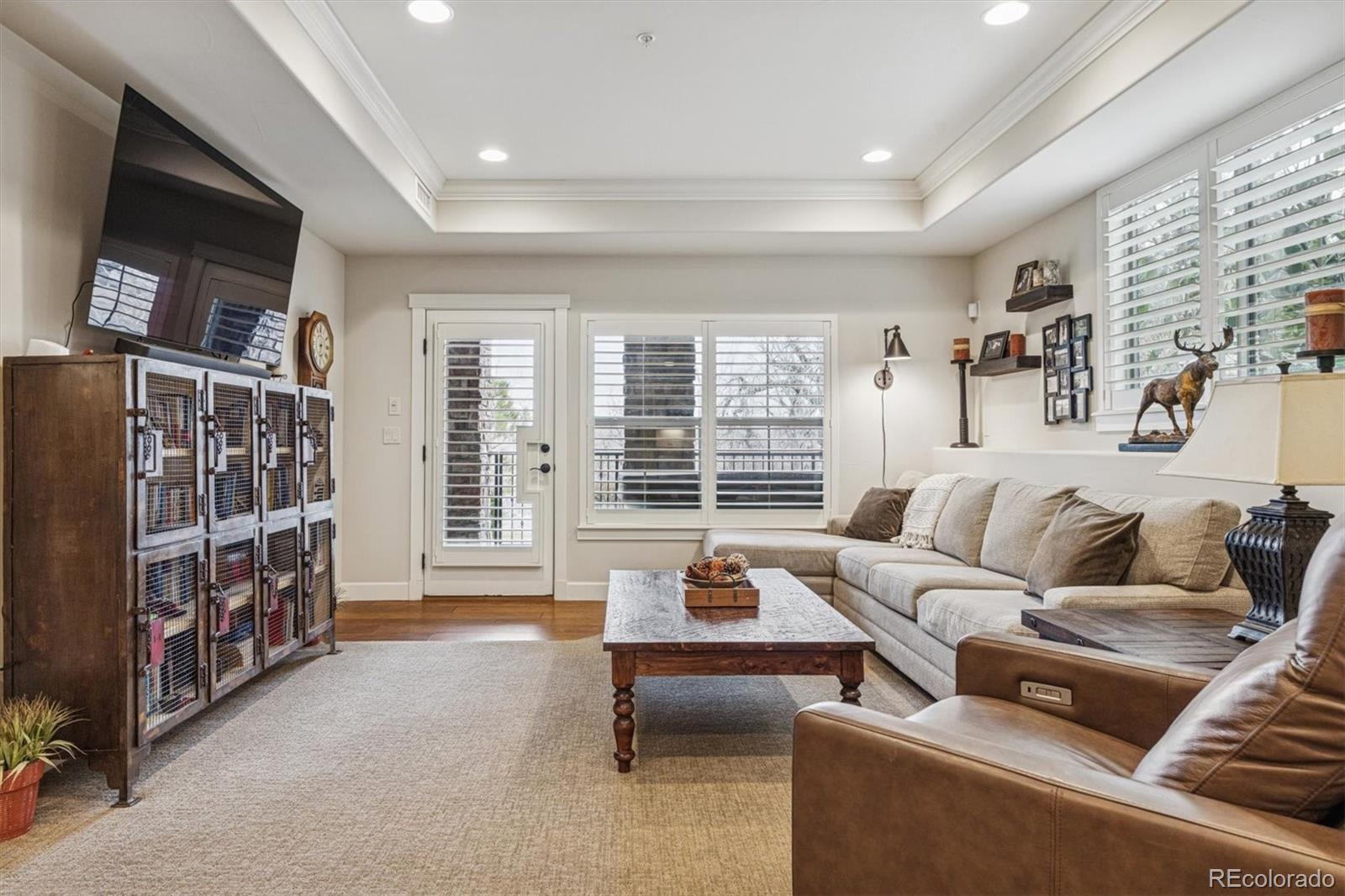 2065 Primo Road, Unit F Highlands Ranch, CO 80129 - Photo 26 of 37 a living room with furniture hardwood floor and a flat screen tv