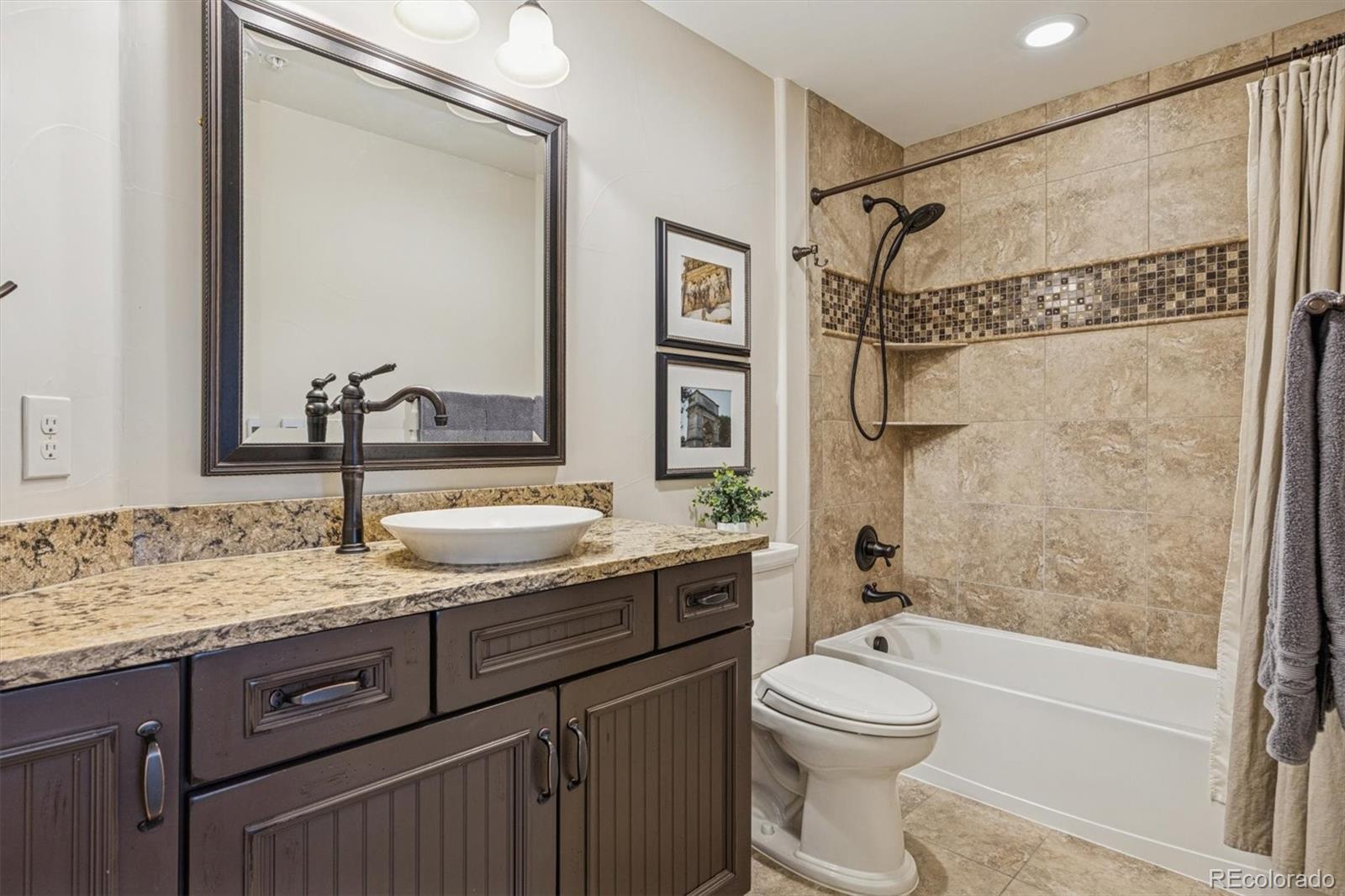 2065 Primo Road, Unit F Highlands Ranch, CO 80129 - Photo 30 of 37 a bathroom with a granite countertop sink toilet and shower