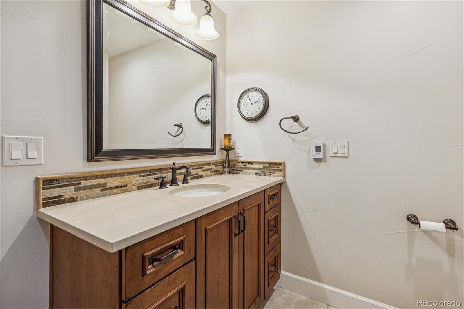 2065 Primo Road, Unit F Highlands Ranch, CO 80129 - Photo 33 of 37 a bathroom with a sink and a mirror