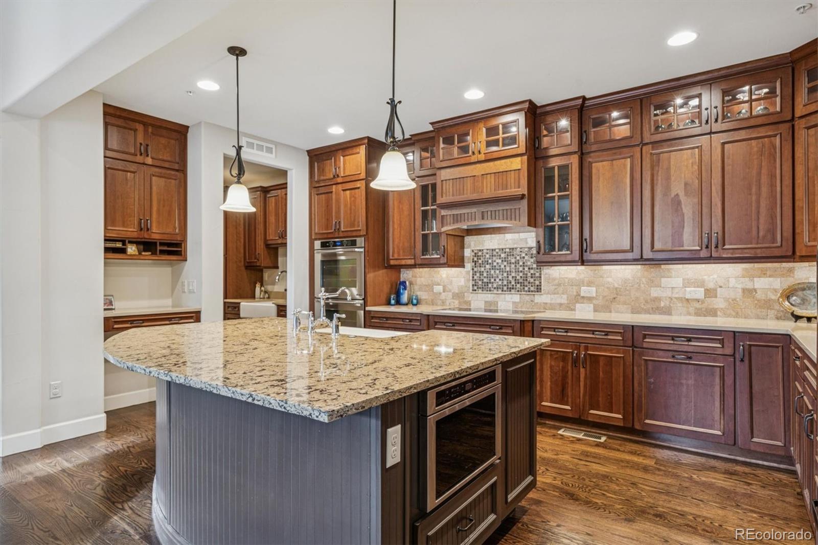 2065 Primo Road, Unit F Highlands Ranch, CO 80129 - Photo 8 of 37 a kitchen with stainless steel appliances granite countertop a sink and a wooden cabinets