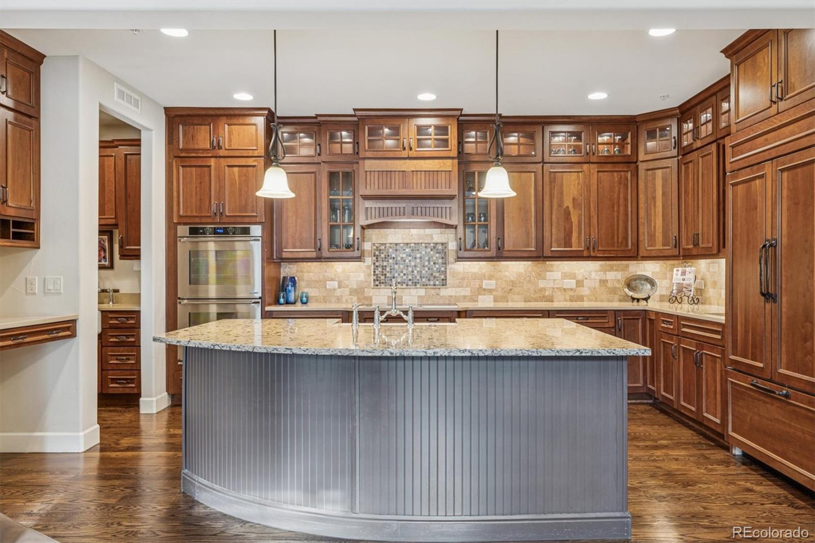 2065 Primo Road, Unit F Highlands Ranch, CO 80129 - Photo 9 of 37 a kitchen with stainless steel appliances granite countertop a sink refrigerator and cabinets